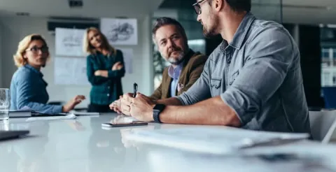 An innovative leader presenting strategic business solutions to a diverse team in an office.