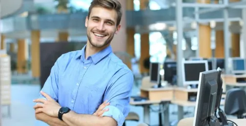 Healthcare professional smiling at the camera, dedicated to promoting public health and wellness initiatives.