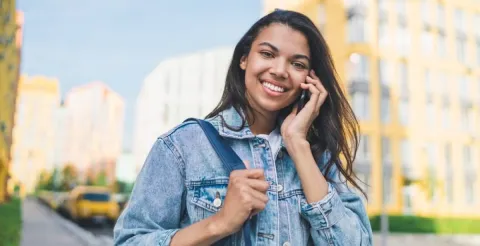 Student smiling on camera while discussing the flexible benefits of an MBA program.