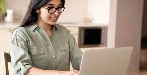 Girl smiling while working and reviewing career pathways in the public health sector.